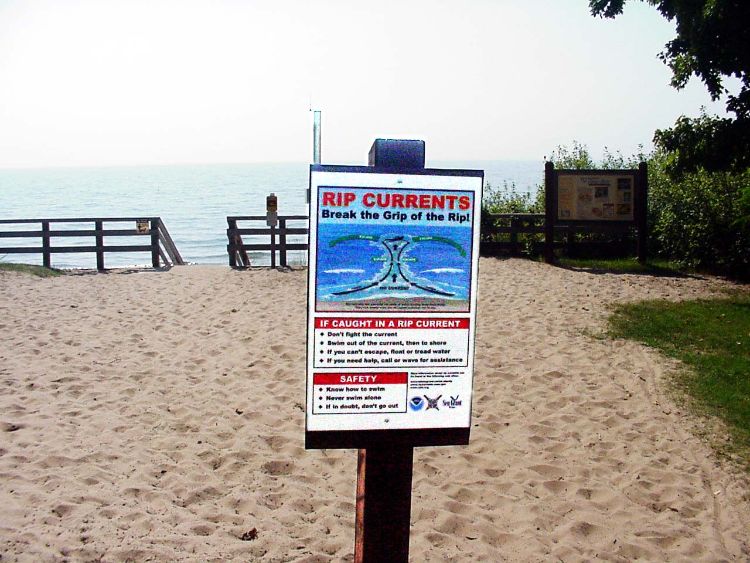 Rip current sign at an Upper Peninsula Great Lakes beach.