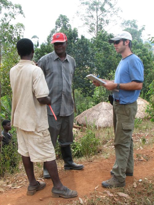 CHANS-Net member Joel Hartter conducts an interview through his field assistant and interpreter Peace Mwesigwe with a local resident from the Bakiga tribe in a village near Kibale National Park.