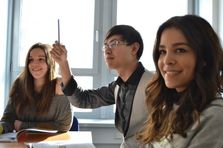 People sitting around a table smiling.