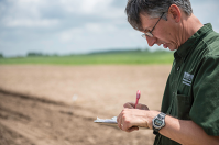 Dave Douches stands in the field.