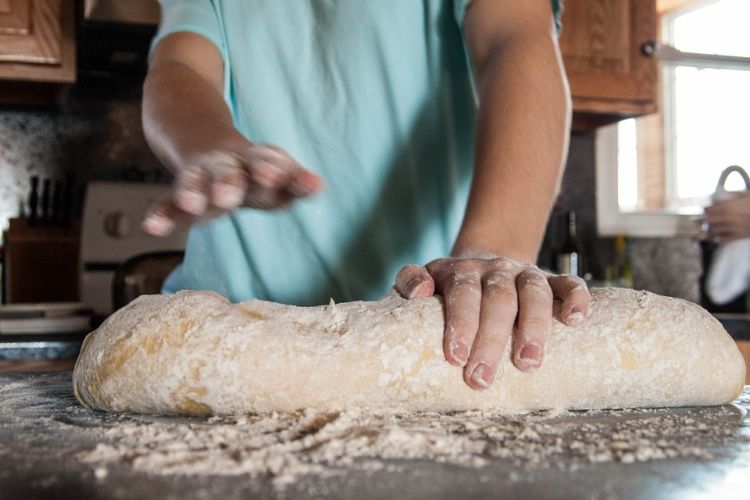 Adults can model self-efficacy through learning opportunities such as baking bread.