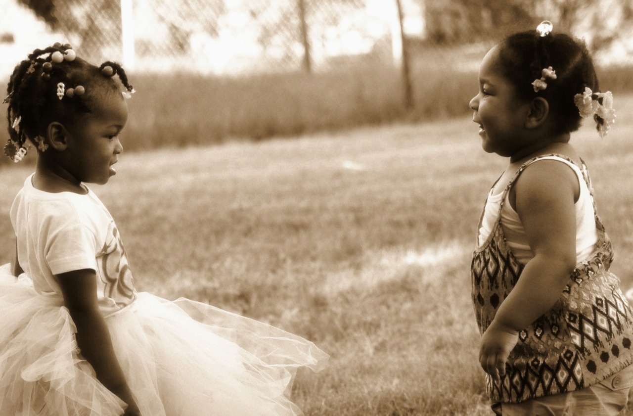 black and white babies playing together