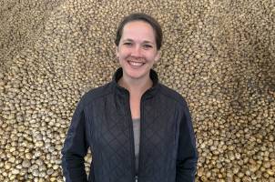 Kendra Levine in front of potatoes, Michigan State University Department of Agricultural, Food, and Resource Economics
