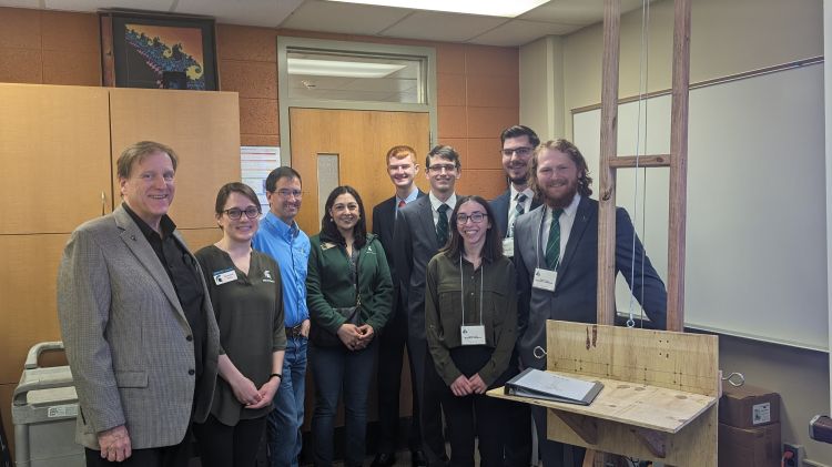 photo of people listed in the caption standing in a room