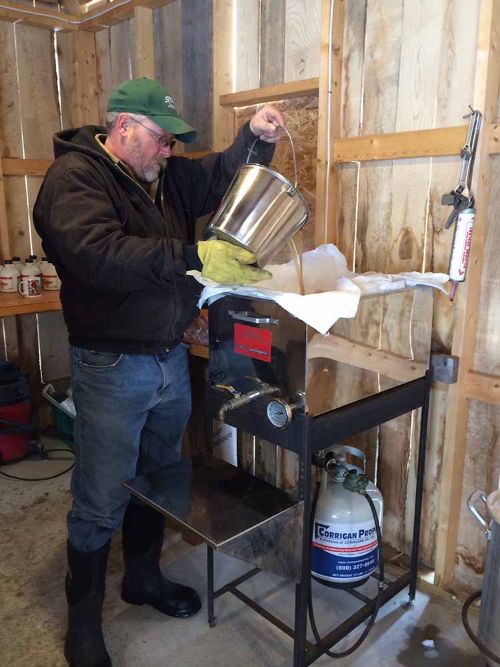Mike Lucks working in his sugar shack to turn maple sap into syrup!