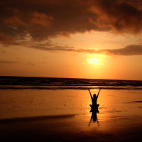 Person meditates on beach