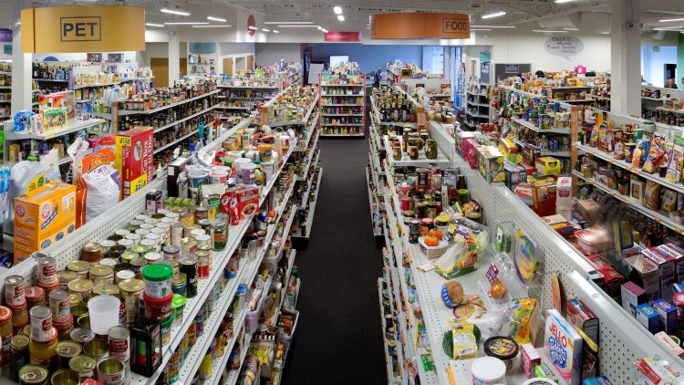 The NewProductWorks Collection, an inventory of packaging items displayed in a simulated supermarket setting.