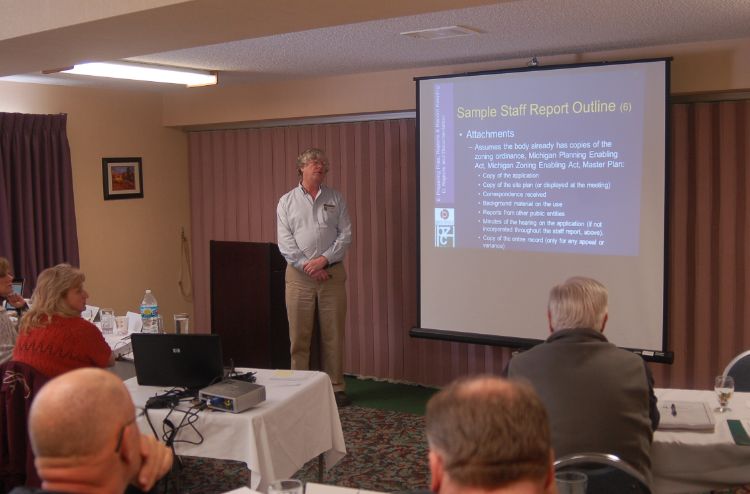 Schindler explaining staff reports at the Land Policy Institute/MSU Extension 