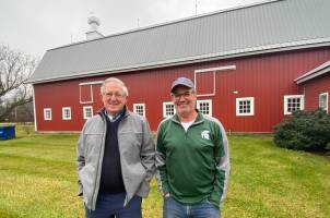 William (Bill) Oswalt and his son Mike Oswalt, also an MSU animal science alumnus on their family farm.