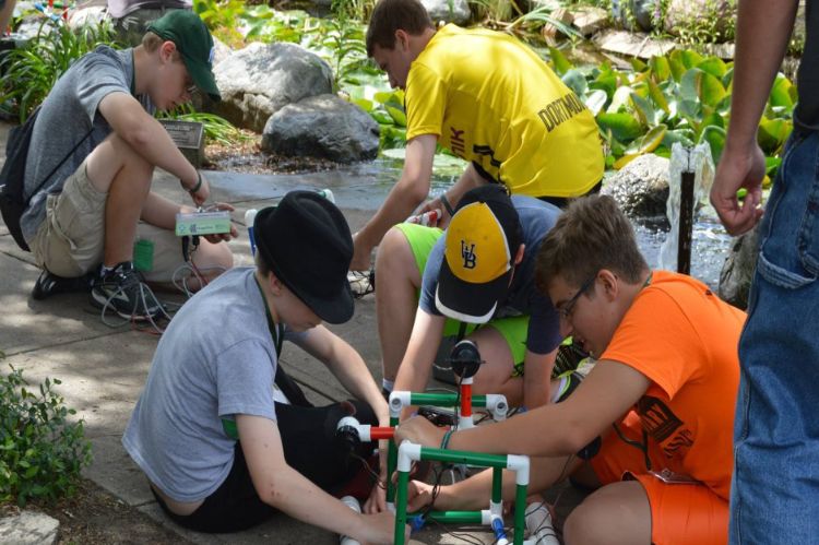 Youth put together pipes.