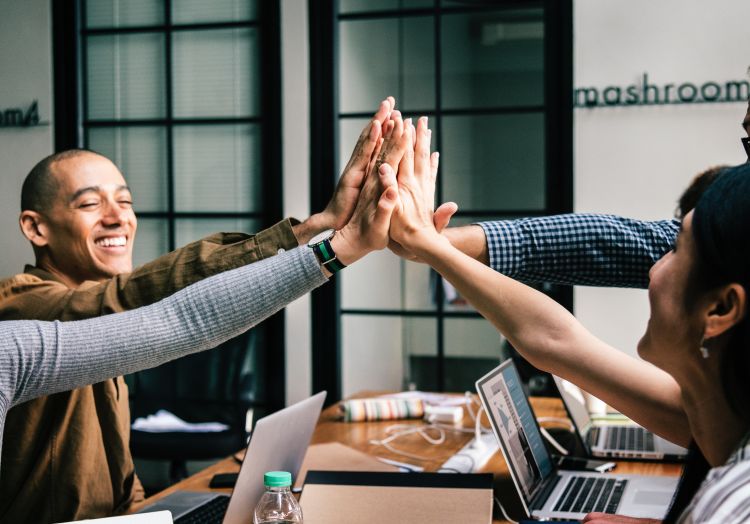 Group high-fiving each other