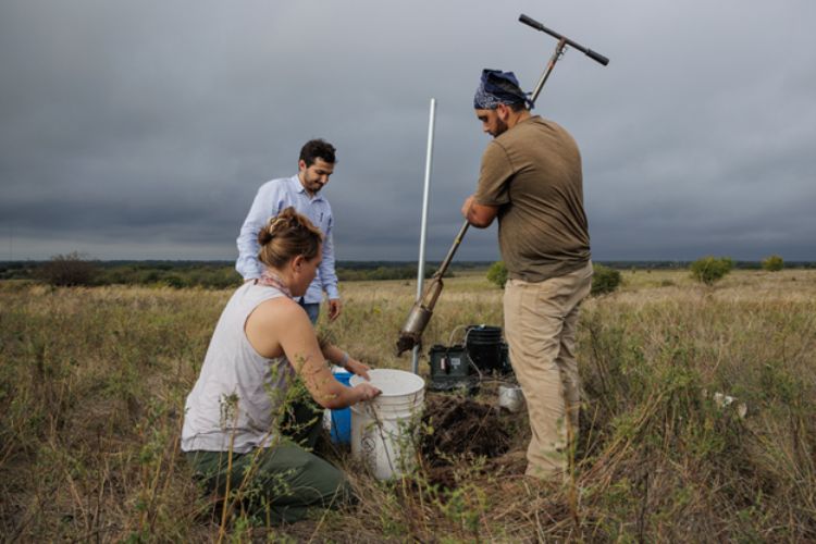 Image showing three IWR scientists conducting fieldwork in a rangeland.