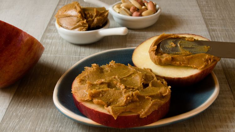 Peanut butter spread on apple slices.
