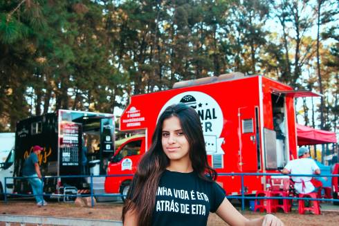 Woman standing in front of a food truck.