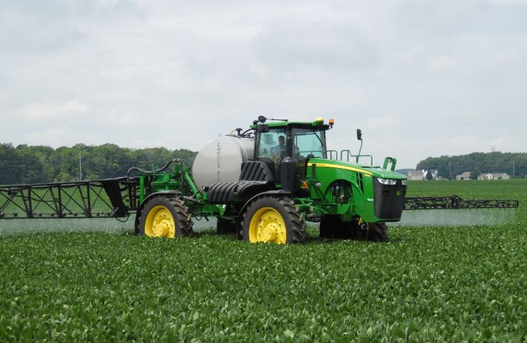 A tractor spraying a field.