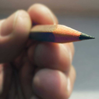 Person holding pencil up-close view