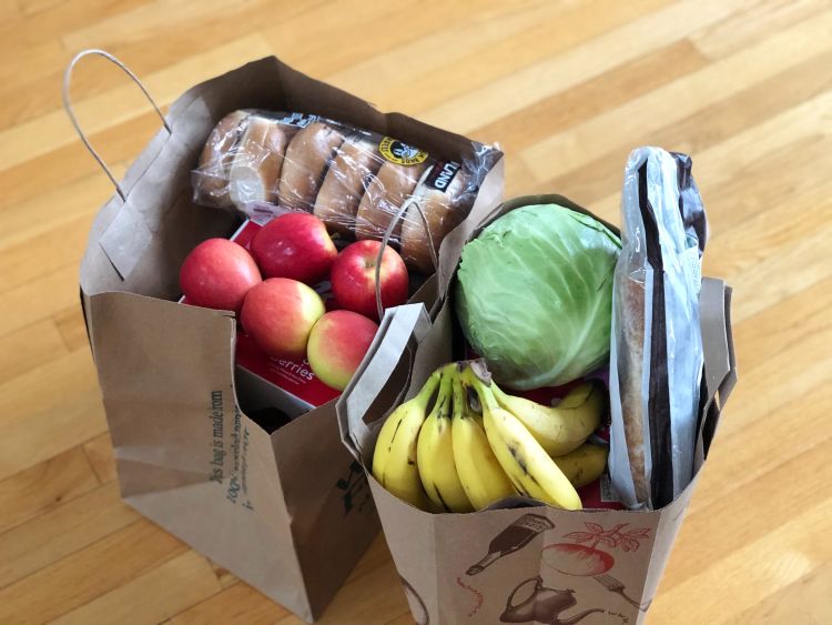 Two paper bags of produce and groceries.