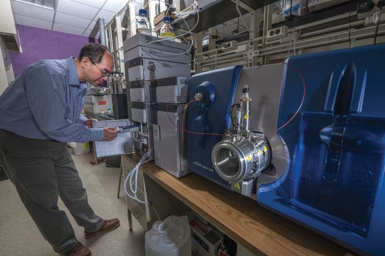 Hui Li with the liquid chromatography-tandem mass spectrometer in his lab.