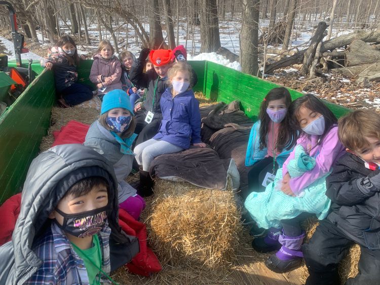 Campers climbing on an old John Deer Tractor on a gloomy winter day!