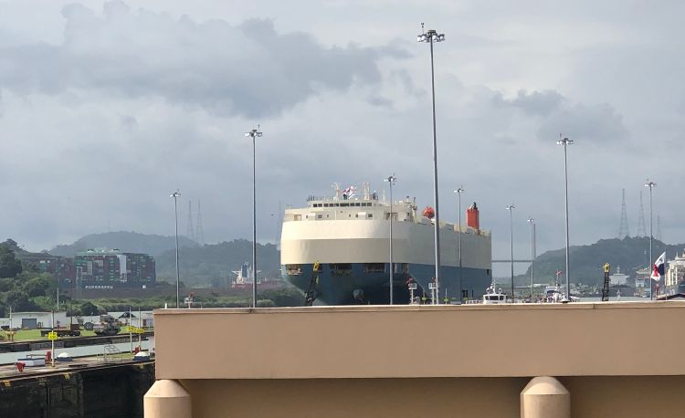 A ship moving goods through the Panama Canal