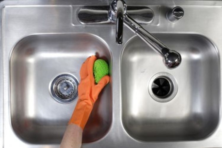 Hand cleaning a sink