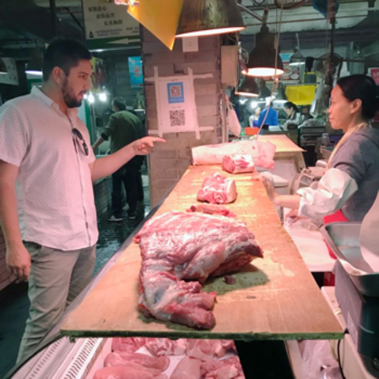 David Ortega at a pork market in China