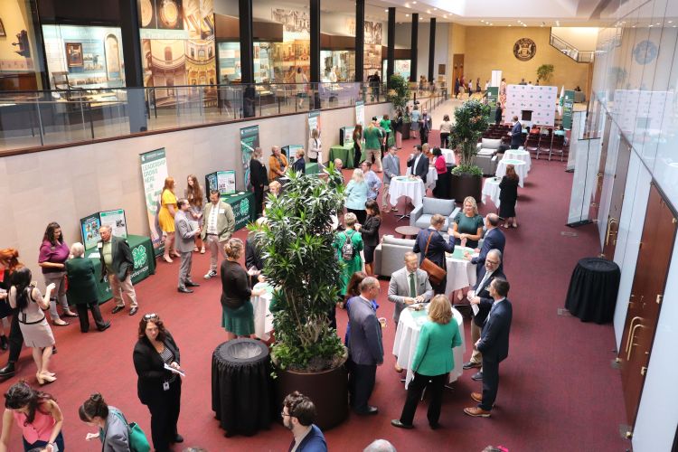 Many people in a room with 4-H displays.