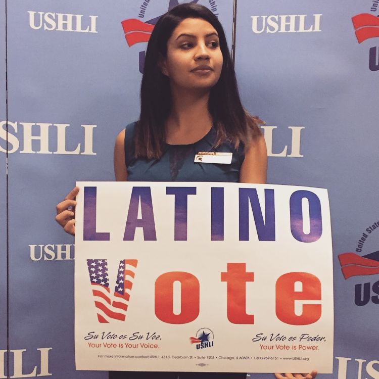 Alondra Alviso poses with a Latino Vote sign.