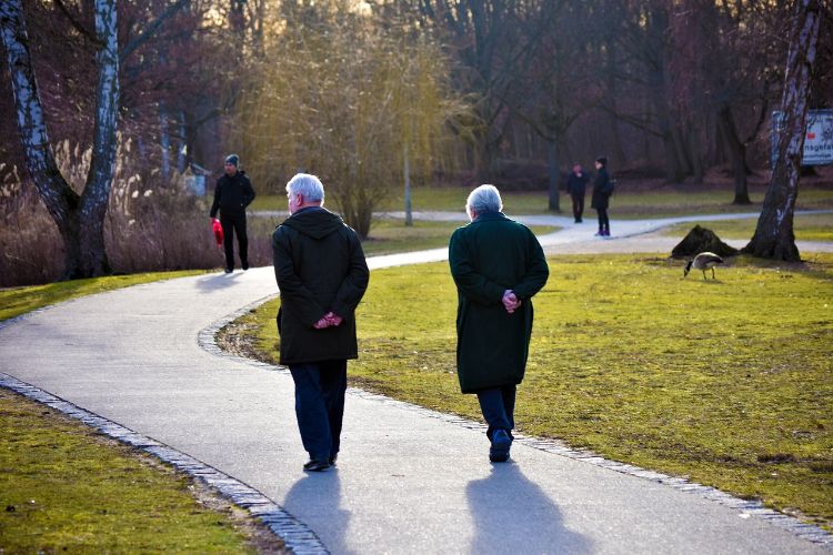 Two elderly people walking.