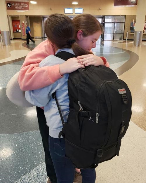 Nino hugging her host sister goodbye at the airport.