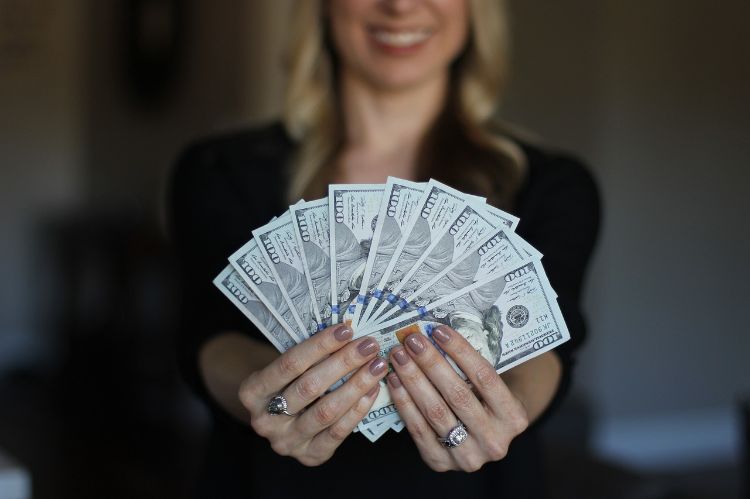 A woman with a handful of money.