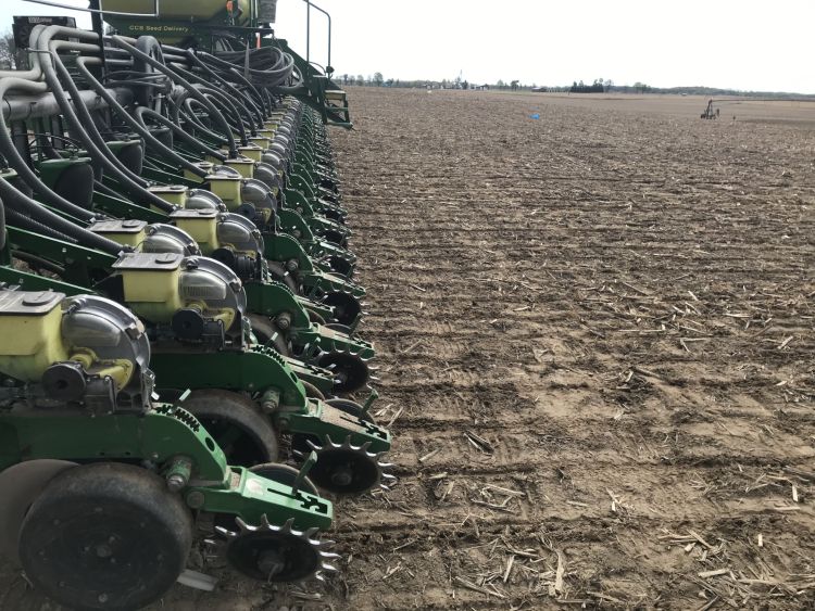 A John Deere tractor with planter preparing a field