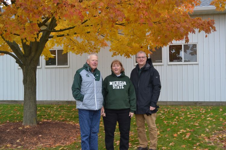 Carl Lindquist and Joy Vietinghoff with CANR Dean Ron Hendrick under a tree at the MSU horse farm.