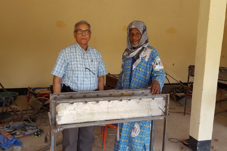 Ajit Srivastava (left) works with smallerholder farmers in Burkina Faso to help develop solar technologies for drip irrigation systems.