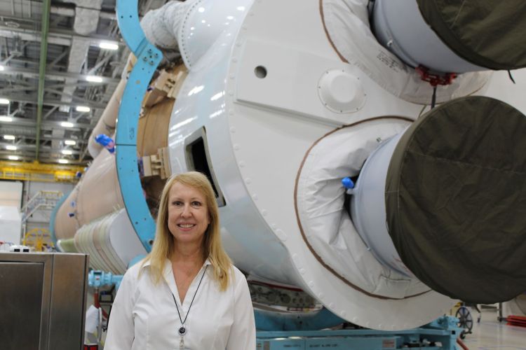 Kristen Haugaard standing by a rocket ship engine