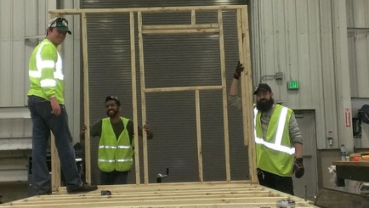 Ryan Daniels (photo right), Civil Engineering student, working with other studetns on the Sparty's Cabin build