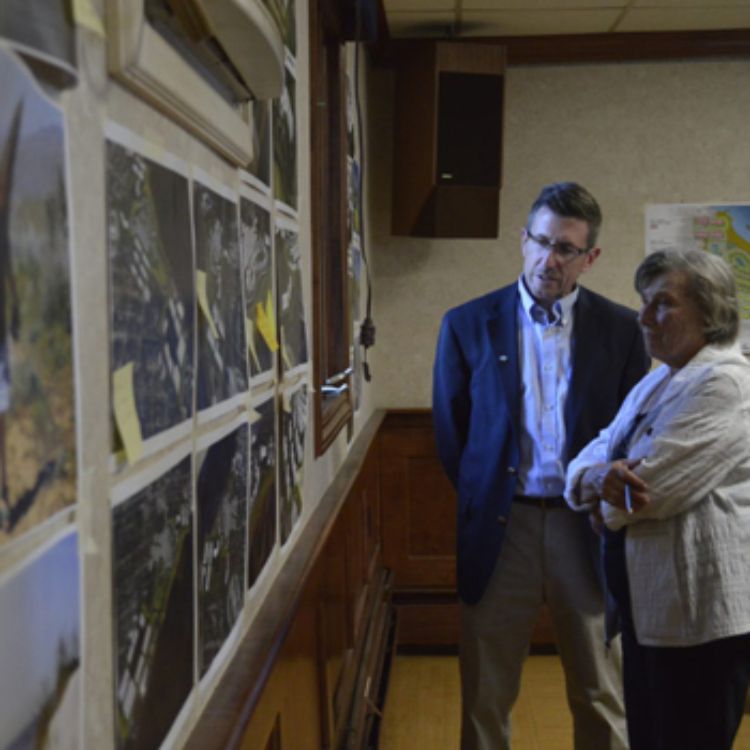 SPDC's Wayne Beyea discusses the images on the Gladstone Yacht Club wall during North Shore Project meeting