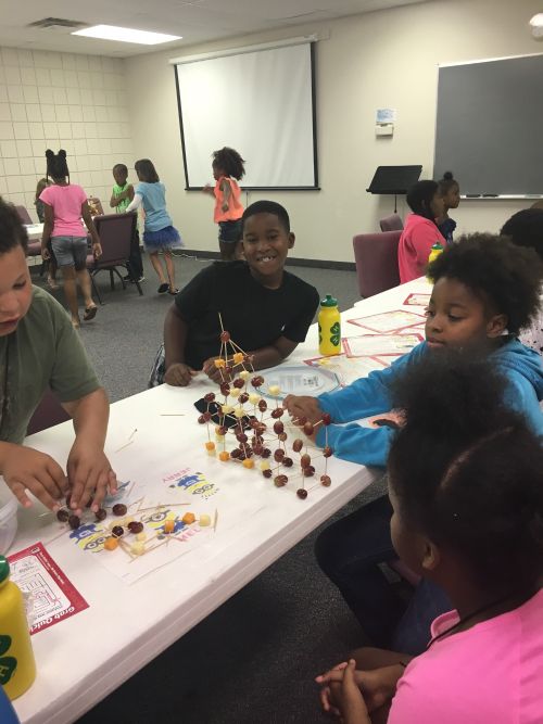Youth in Genesee County build a cheese and fruit tower in 4-H Healthy Habits UDIM Summer Feeding Program.
