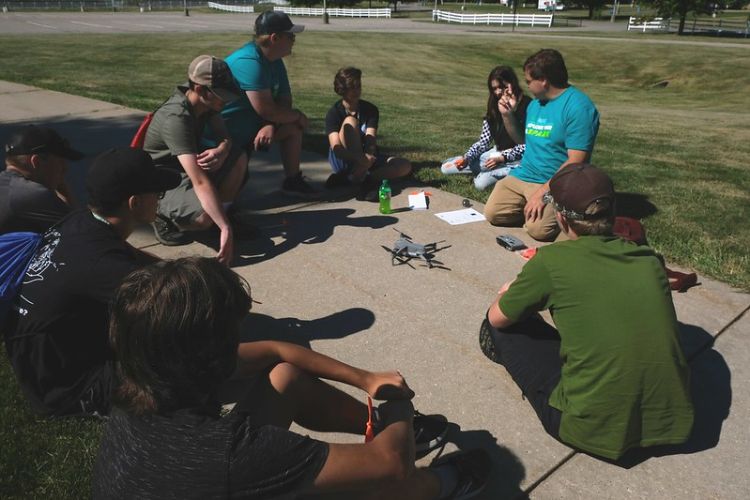 Youth and adults sitting around in a circle.