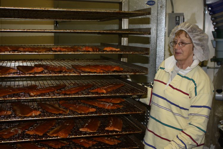 Jill Bentgen (Mackinac Straits Fish Company) with finished smoked fish product in her smokehouse. Ron Kinnunen | Michigan Sea Grant