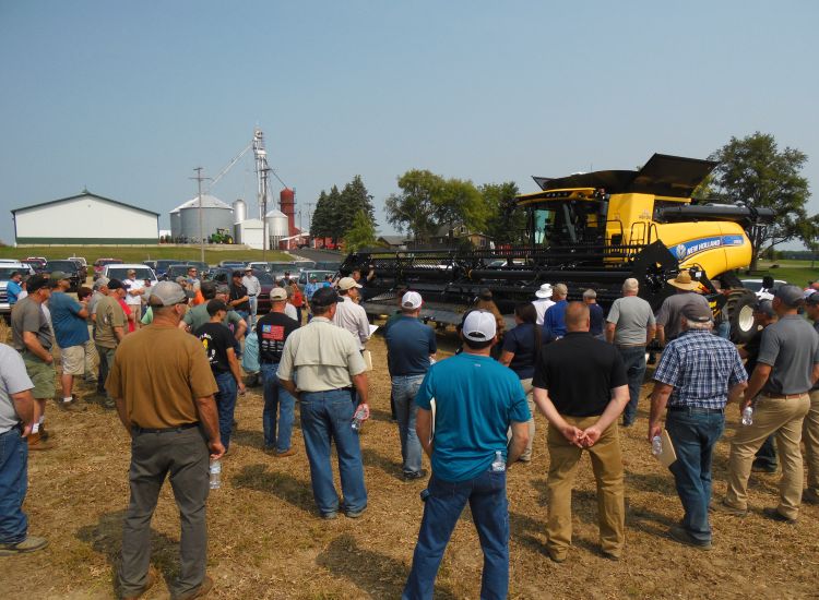 Farmers looking at equipment.