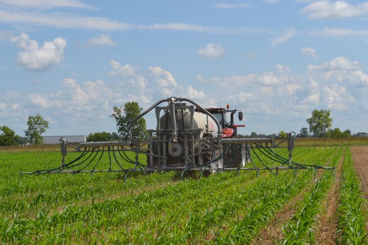 Applying sidress manure. Photo by Charles Gould, Michigan State University Extension.