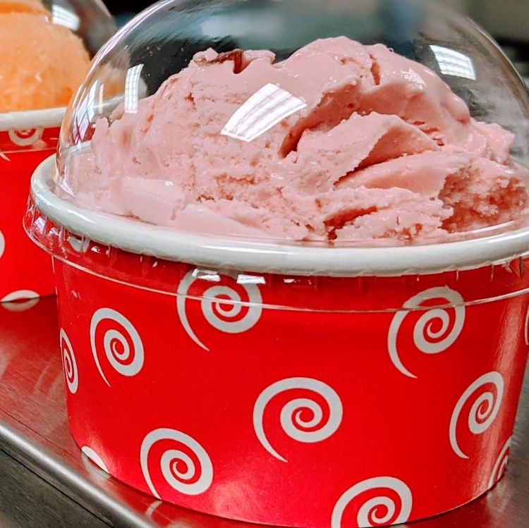 Ice cream scoop in red cup.