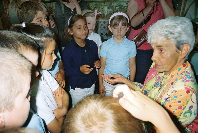 Barb helping out during a tour of the Bug House. Photo by IHM-St. Casimir School.