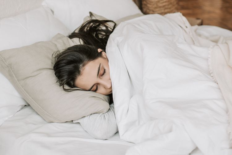 A woman sleeping in a bed