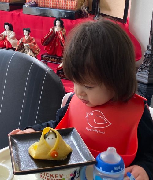 A child enjoying her Eatable Hina Doll