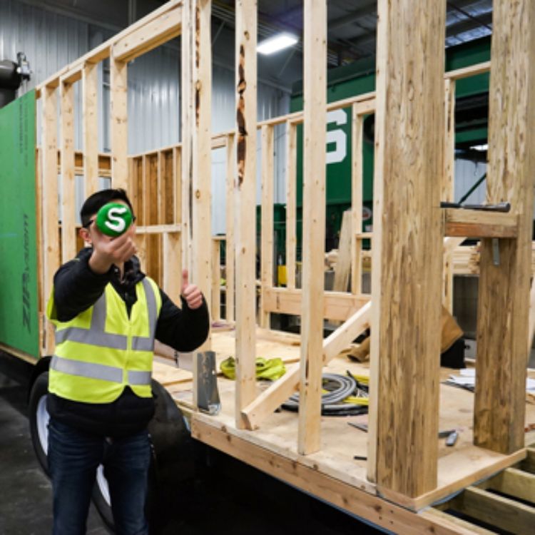 Xiao Hou, senior Landscape Architecture student, at the Sparty's Cabin build site