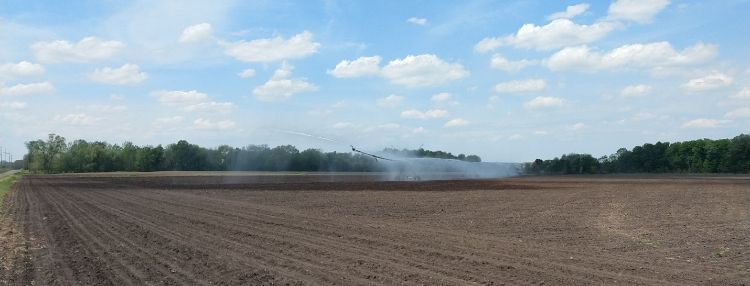 Irrigator in a field spraying water.
