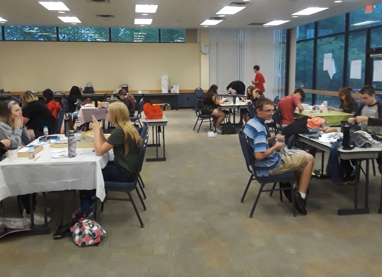 Youth sitting at tables working