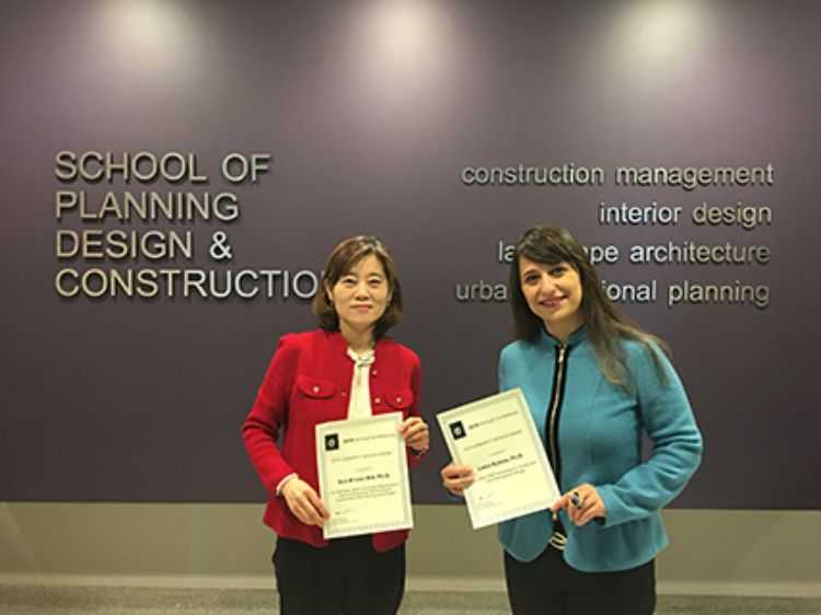 Image of Suk-Kyung Kim and Linda Nubani holding certificates.